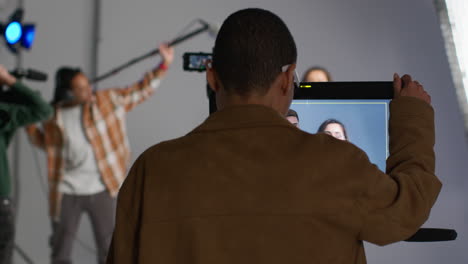 Film-Crew-And-Female-Director-Congratulating-Actors-After-Performance-Shooting-Movie-Or-Video-In-Studio-1